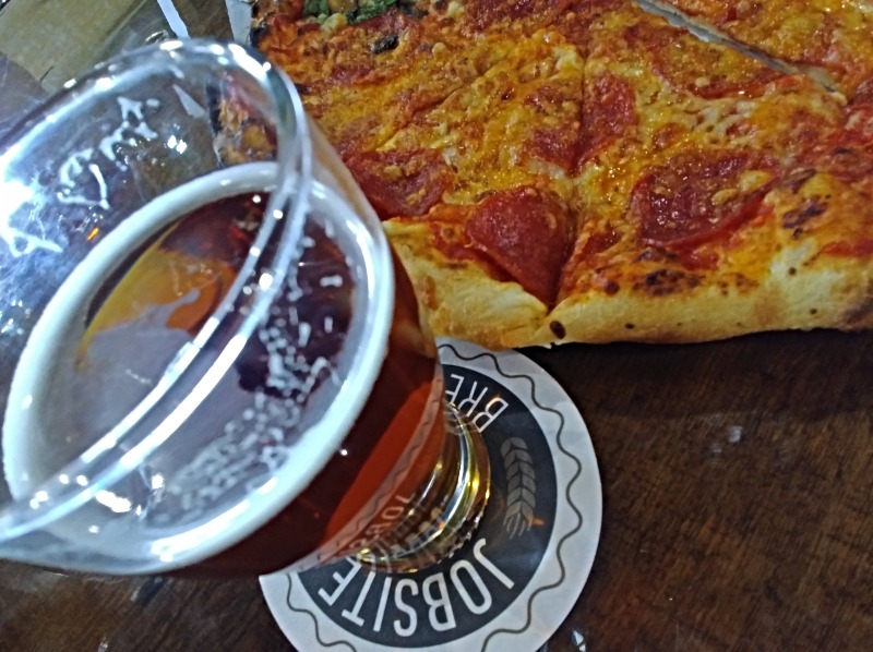 Pint of beer and pizza at Jobsite Brewery