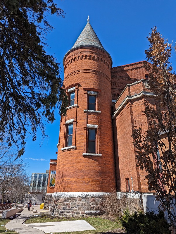 Side profile of historic building, called the Orillia Opera House, with a turret style corner