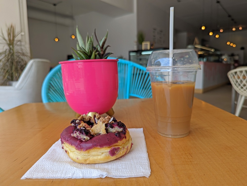 Good Glaze Doughnut with iced coffee sitting on a table