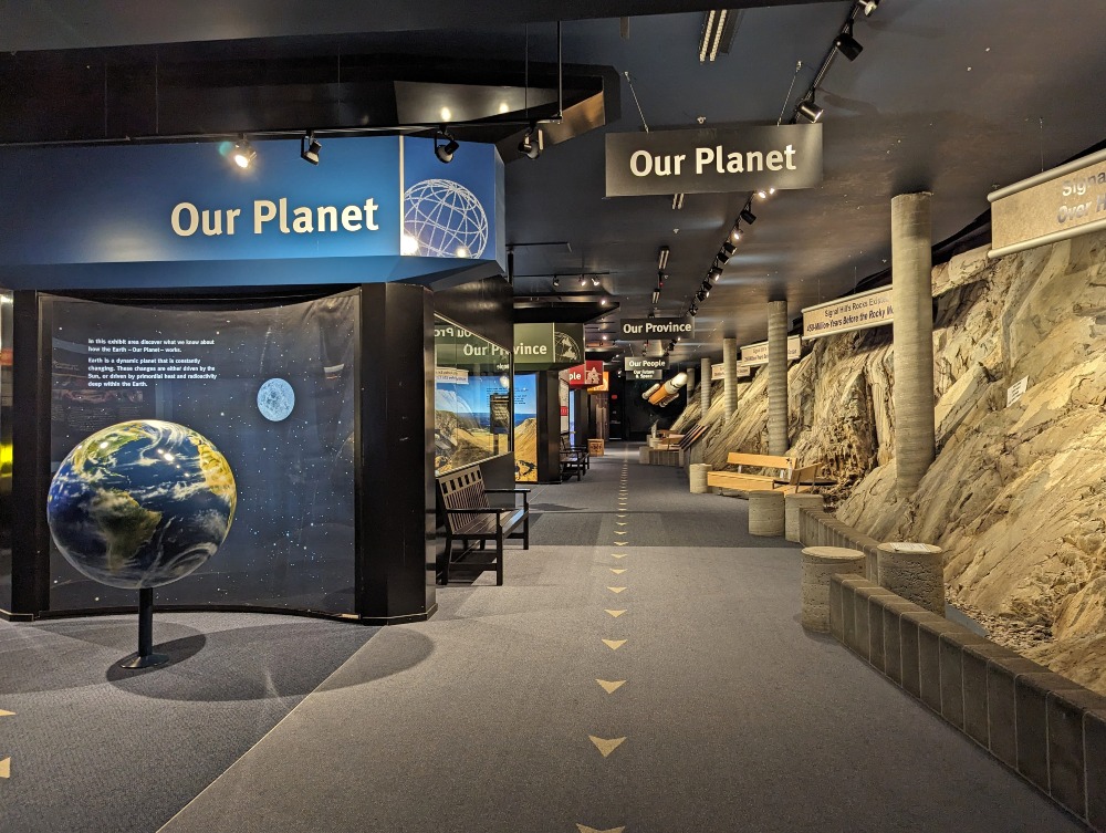 The exhibit hall entrance of Johnson GEO Centre. To the right is exposed rock from Signal Hill and on the left is displays of the Earth