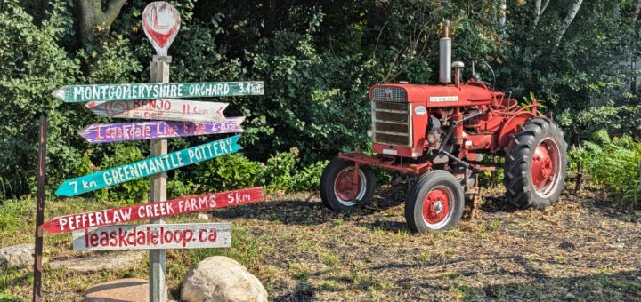 Leaskdale Loop sign beside an old farm tractor