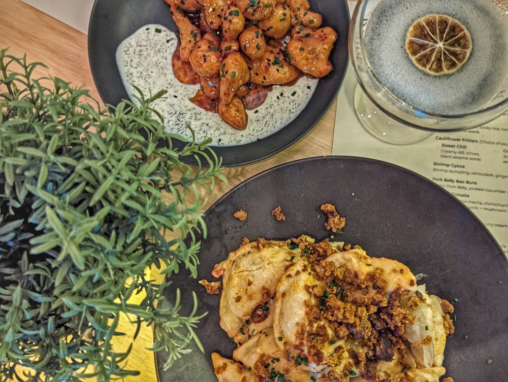 Plates of pirogis, cauliflower fritters, and a cocktail at B’Spoke Kitchen, one of the best Barrie restaurants