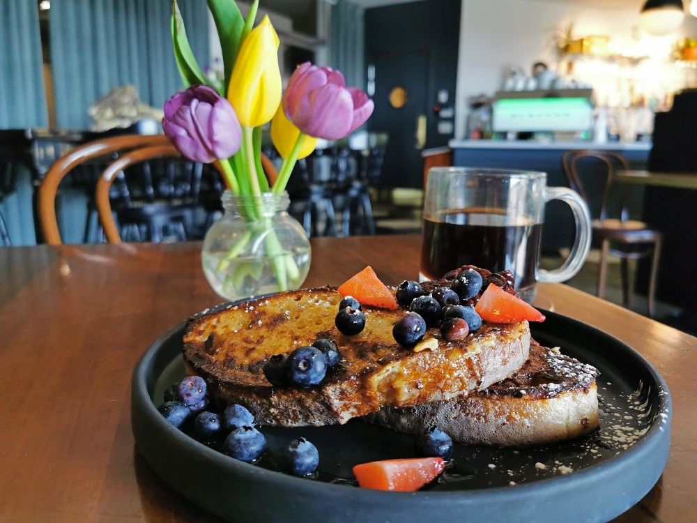 Plate of French Toast with berries on top at Common Good Cafe in Barrie