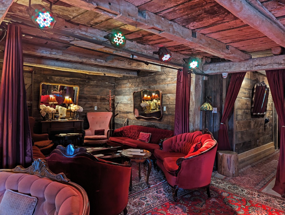 Speakeasy Wine Lounge at Karlo Estates Winery with old wood beams and red velvet Victorian couches and decor