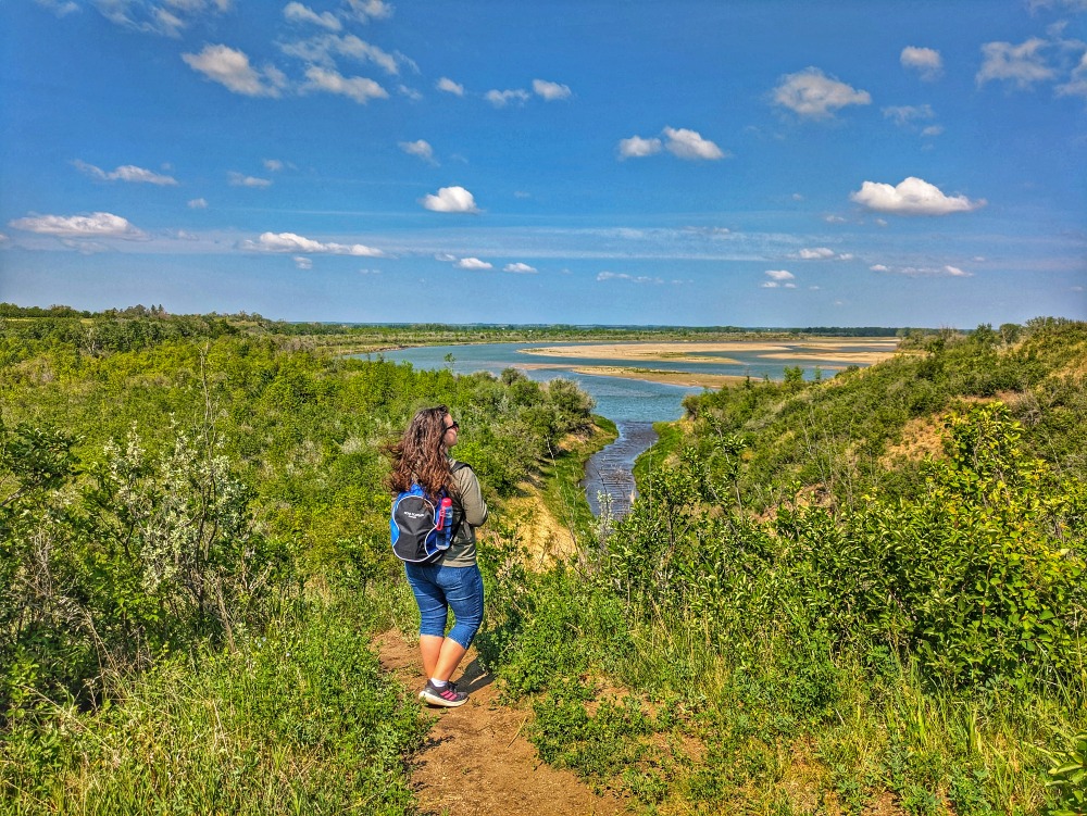 Woman (me) looking out over the river and forest landscape at Beaver Creek Conservation Area