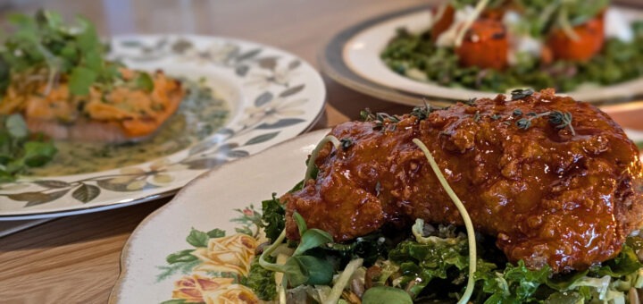 Meals at Hearth restaurant, including chicken in the forefront