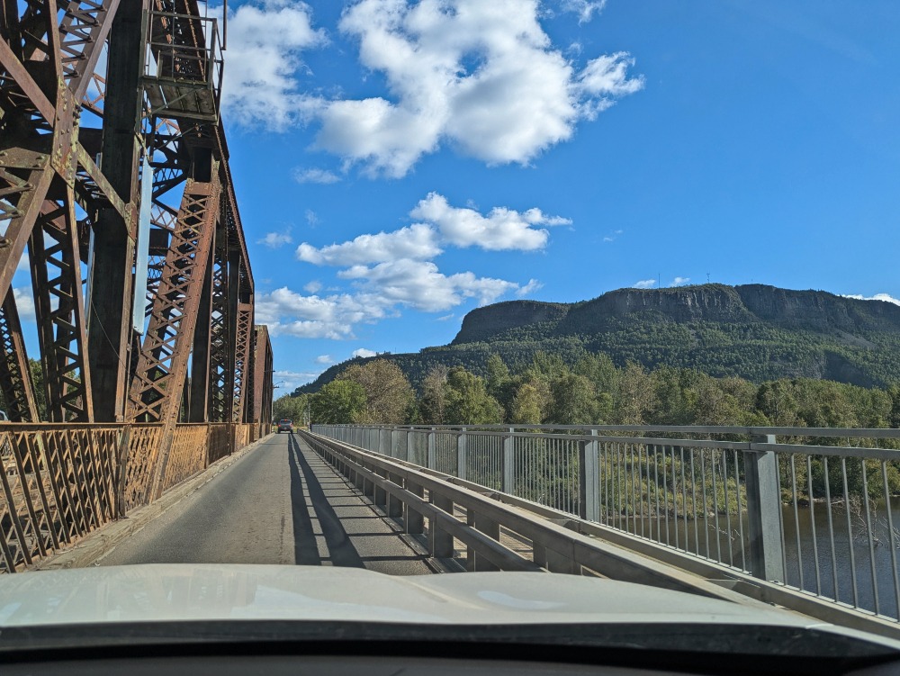 view of Anemki Wajiw (Mount McKay) from car crossing a bridge