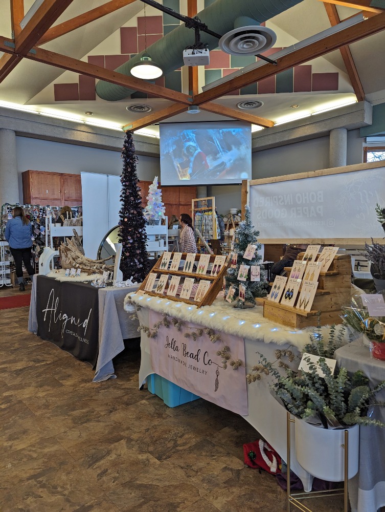 Indoor Christmas market with various booths selling items