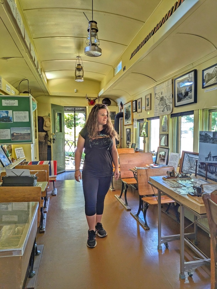 me walking through the school room inside the CNR School on Wheels Museum