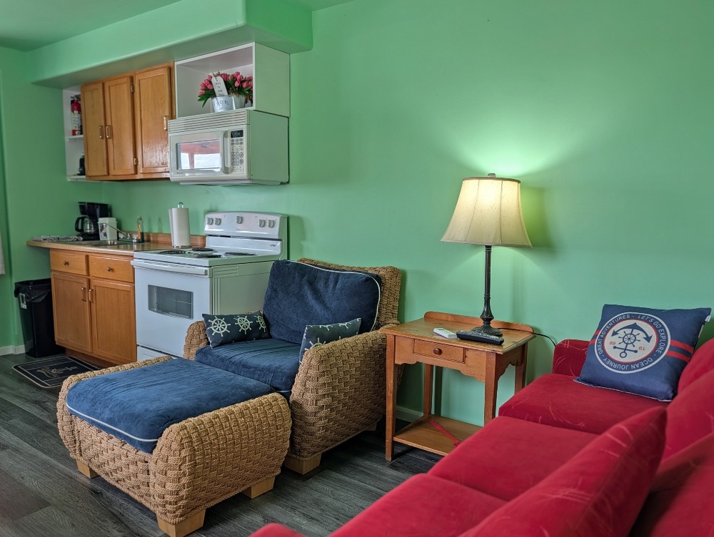 inside Erie-O Motel cozy cottage with seating area and small kitchen