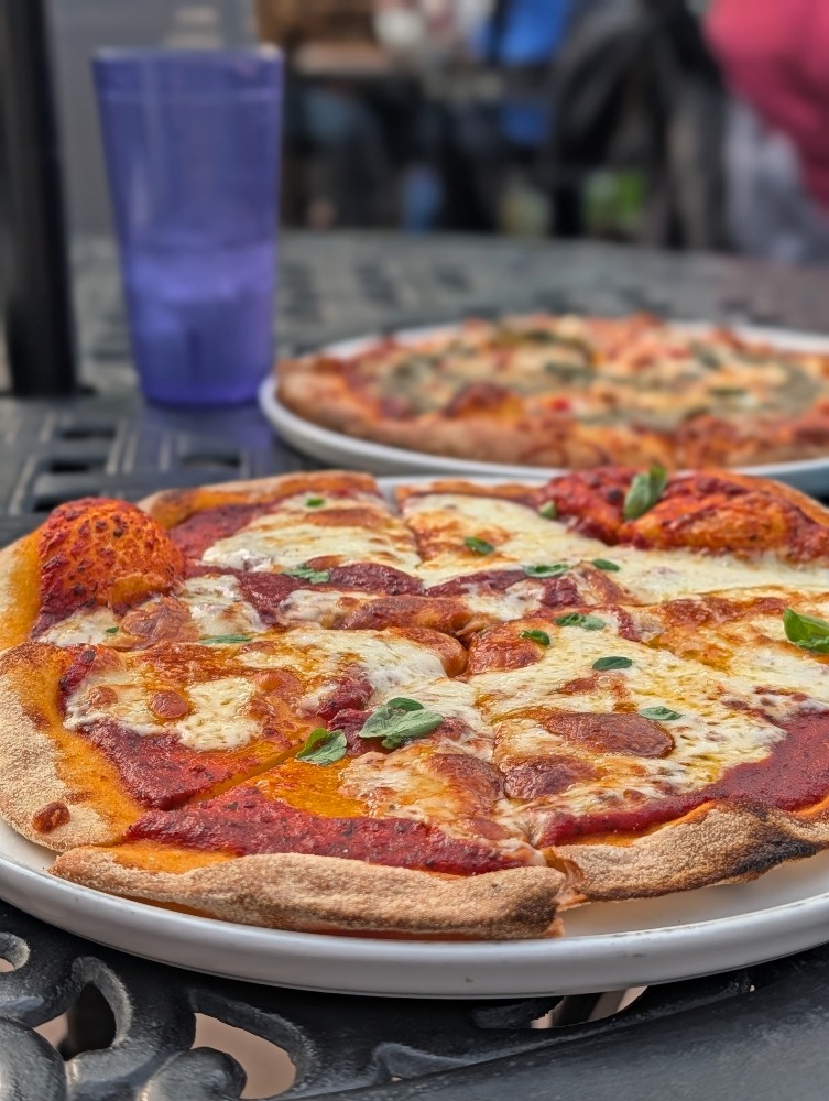 two pizzas on the patio at Bayside Brewery