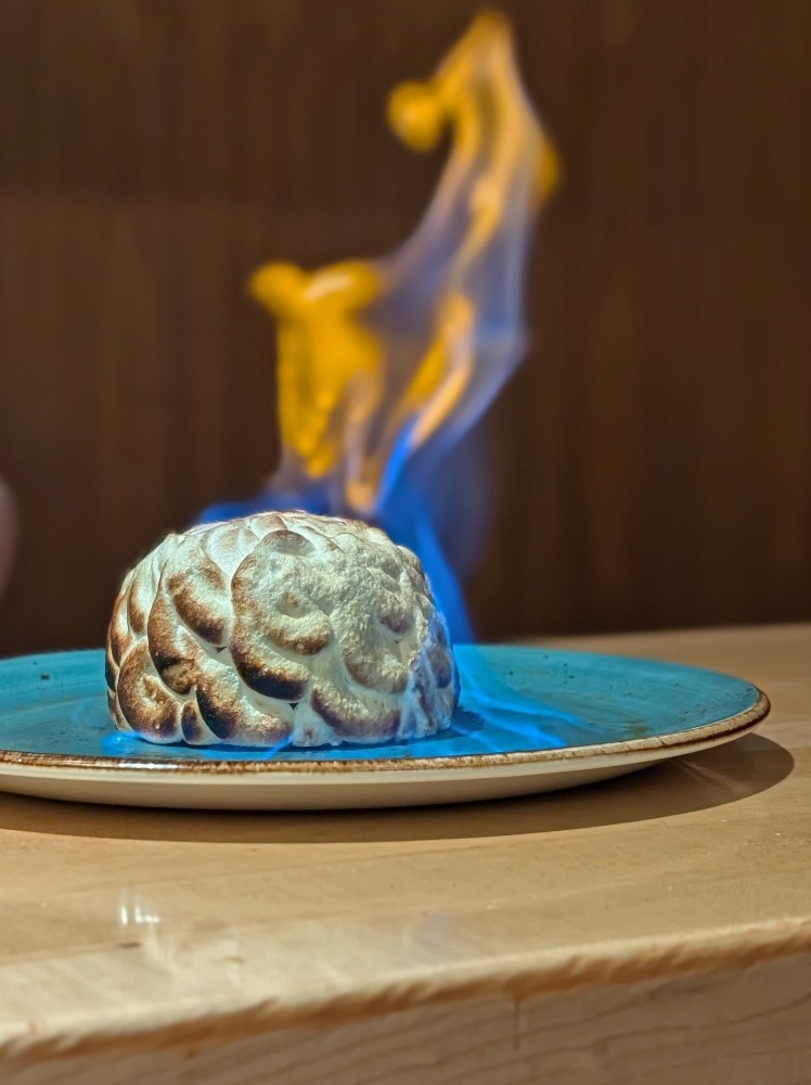 flaming baked Alaskan at Atlas Steak and Fish restaurant in Burnaby