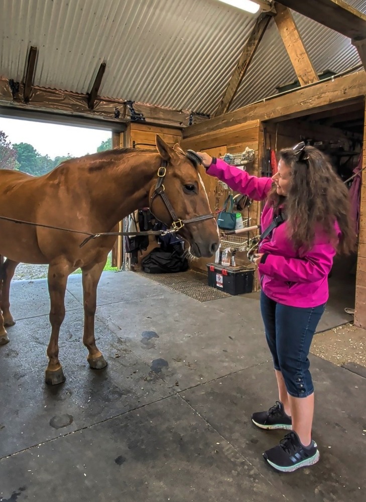 me grooming a horse at Maplestone Ranch