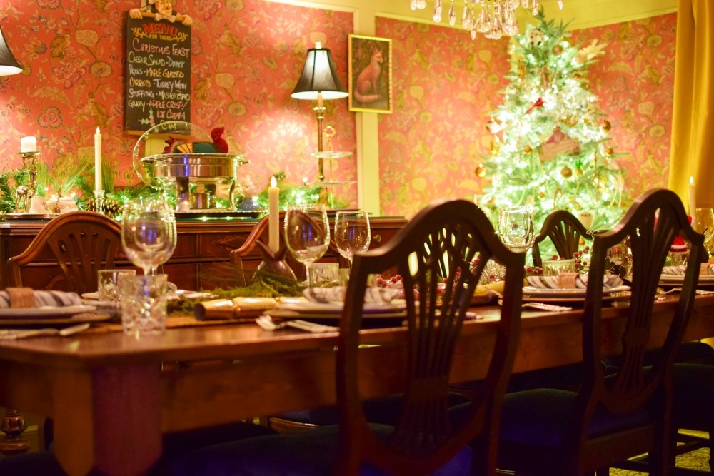 Christmas at The Old Mill Manor with a Christmas tree in the dining room and table set