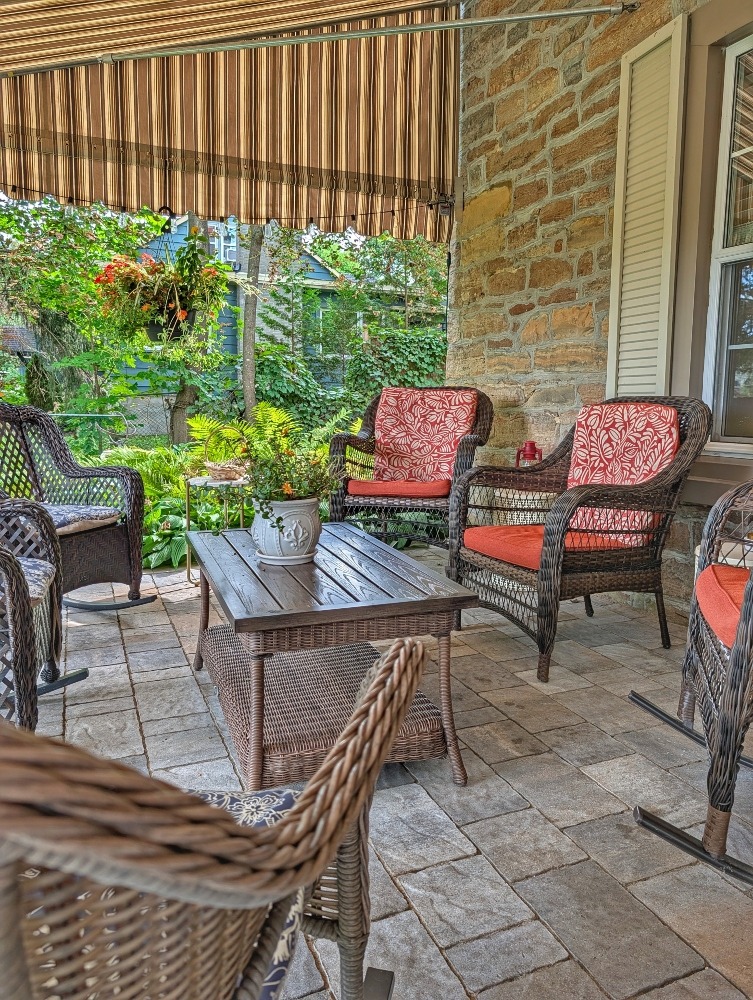 front patio seating area with a number of chairs and a coffee table