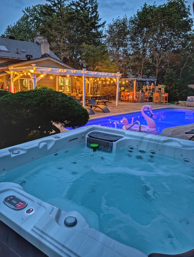 hot tub, pool and back patio at the Old Mill Manor at night with lights