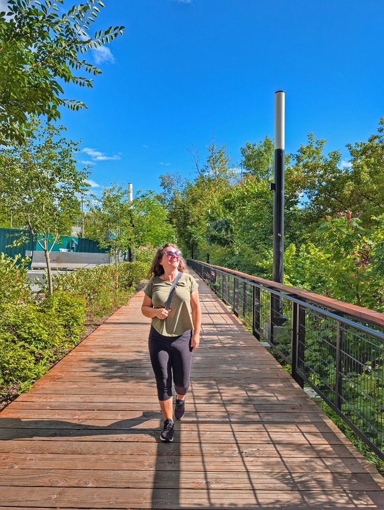 me walking along the riverfront boardwalk