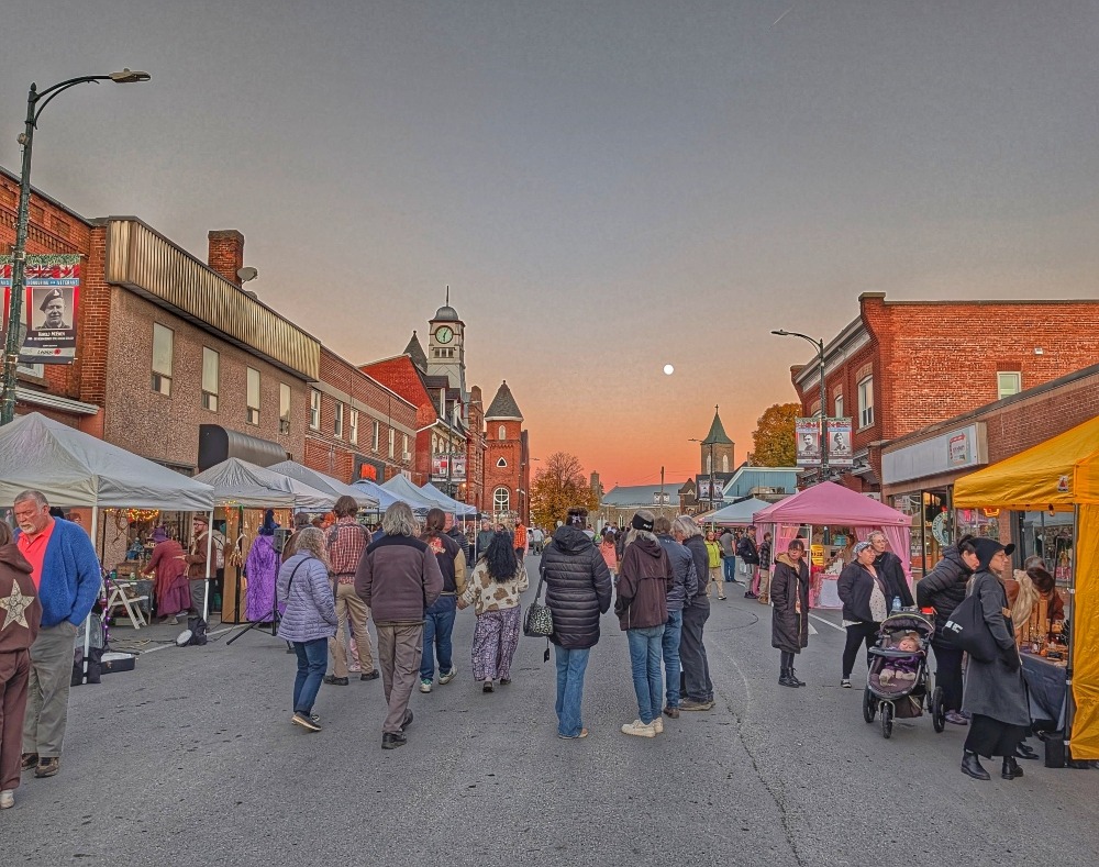 The Mystic Market, with vendors lining a pedestrian only street with the sun setting in the distance